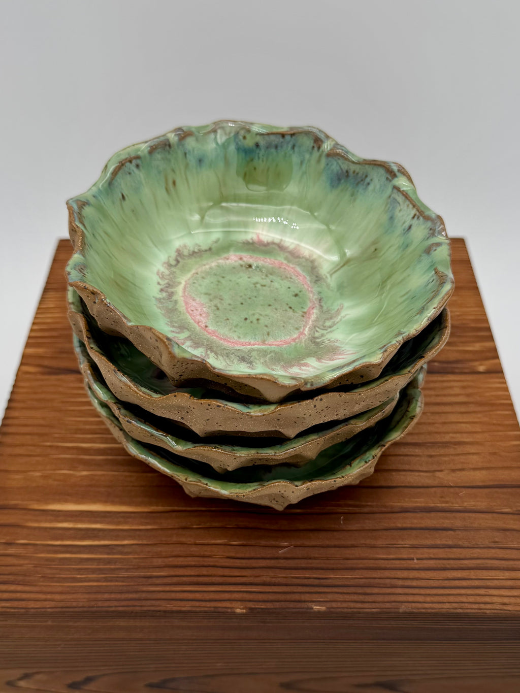 Side view showing speckled earthy exterior of one bowl